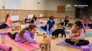Children taking part in puppy yoga with gentle movement and puppy interaction at The Horizon Centre in Berkhamsted.